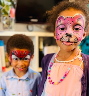 boy with spiderman face paint and girl with pink leopard face paint in Stafford